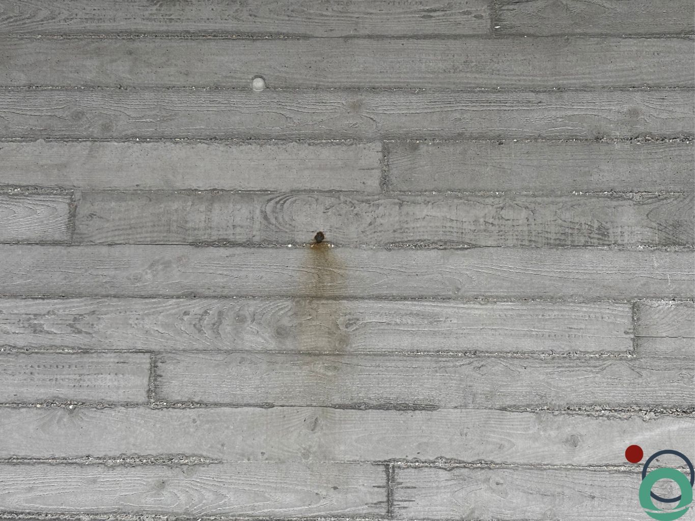 Vervuiling op beton met plankenstructuur